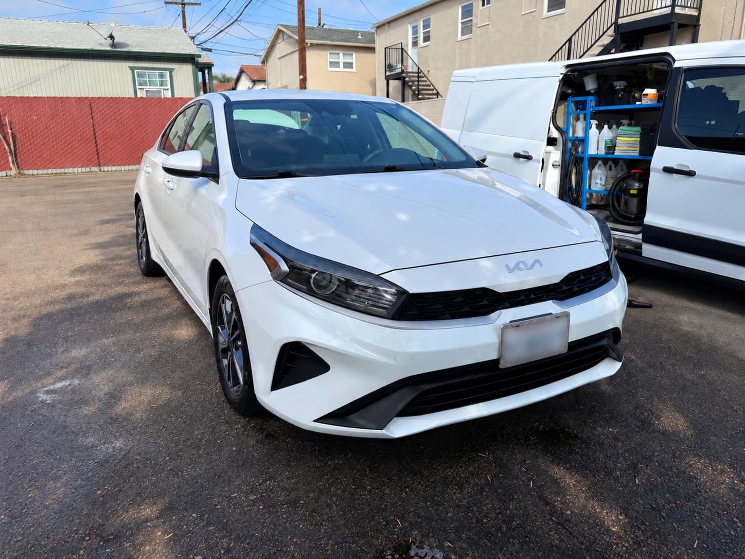 White Kia with a clean exterior after an Express Detail