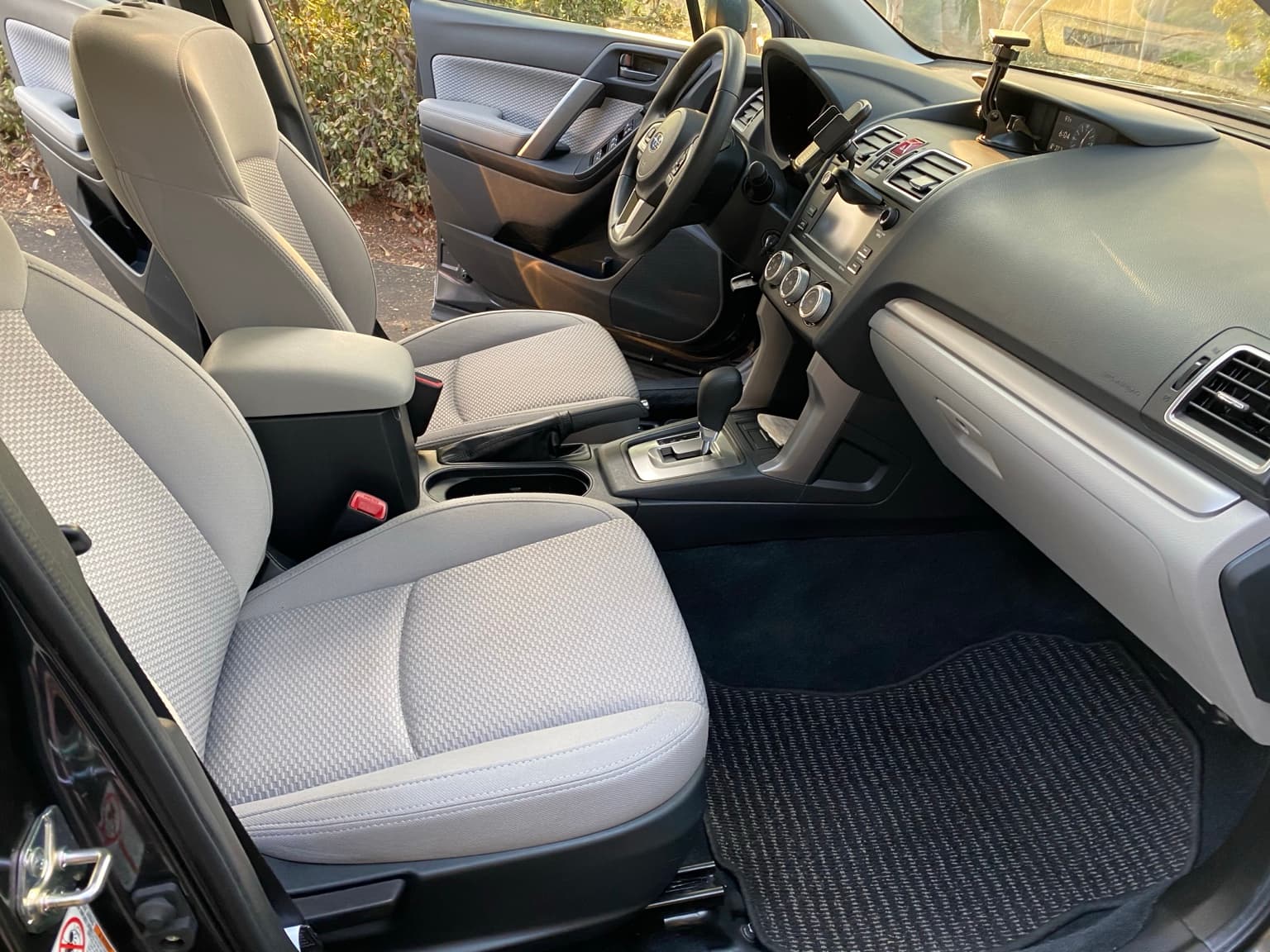 Clean cloth seats, center console and front carpet after an interior detail