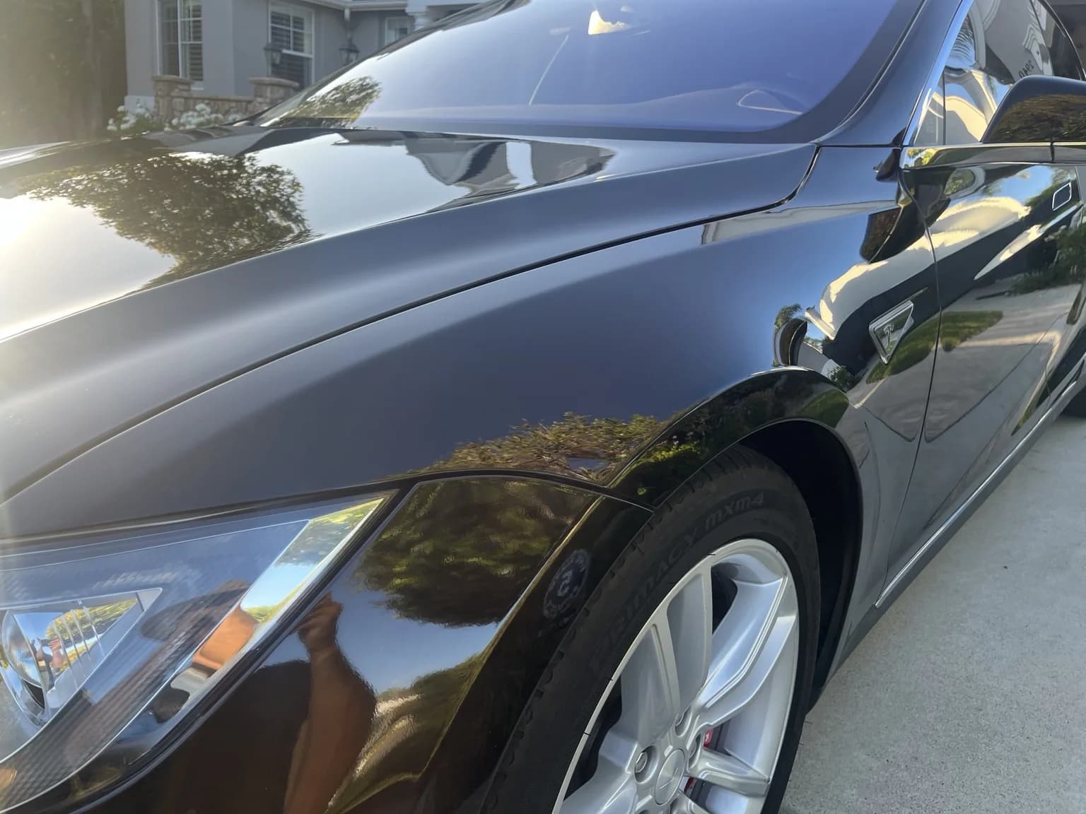 Glossy black Tesla Model S front fender and hood after paint correction and System X MAX G+ ceramic coating