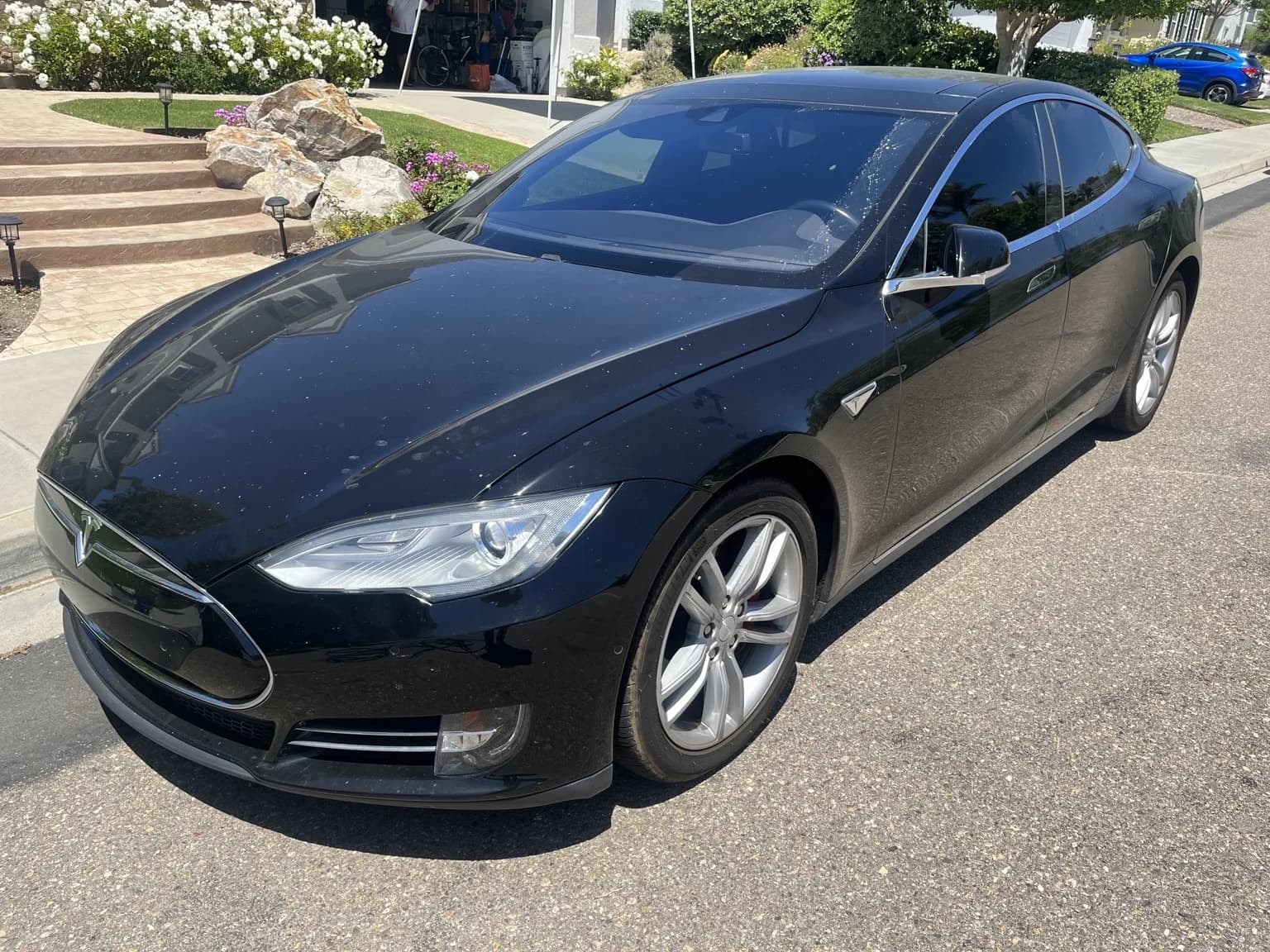 Black Tesla Model S before detailing, viewed from the front