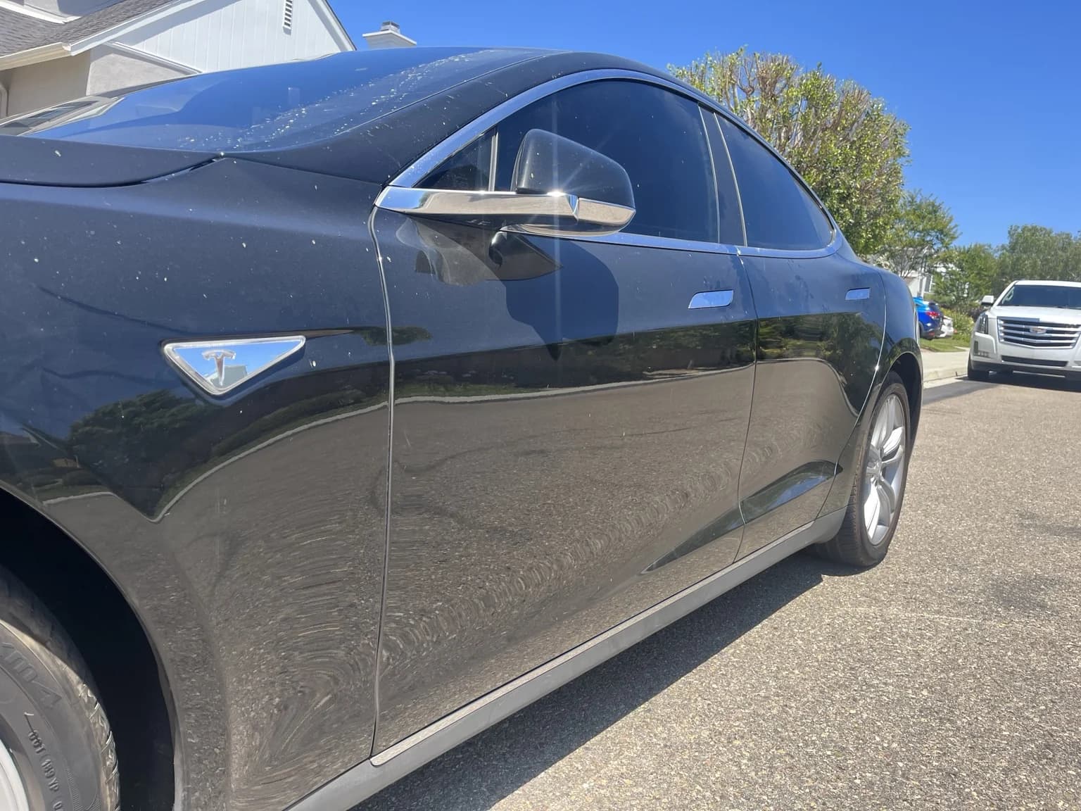 Tesla Model S driver-side doors before detailing, with visible dirt and spots